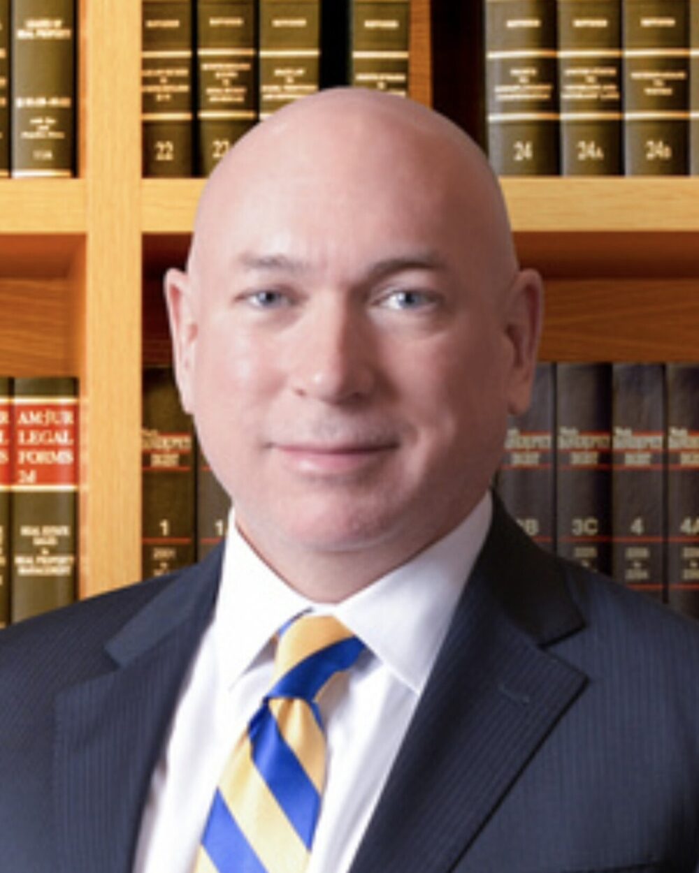 Ken Hendren, Esq., CPA, estate planning attorney in Birmingham, Alabama, photographed in front of a law library